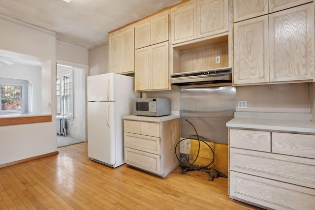 kitchen featuring radiator, white appliances, crown molding, light hardwood / wood-style flooring, and light brown cabinets