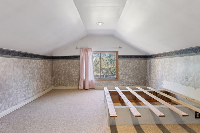 additional living space with lofted ceiling and carpet flooring