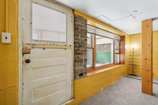 doorway to outside featuring carpet floors