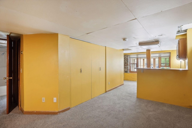 basement featuring light carpet