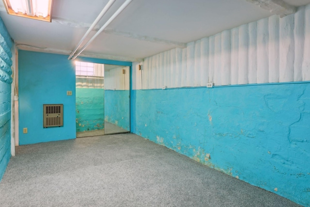 basement with carpet floors and heating unit