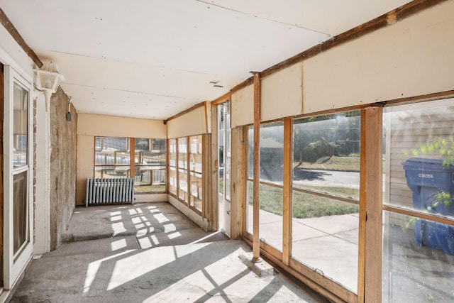 unfurnished sunroom featuring a wealth of natural light and radiator