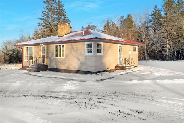 view of snow covered rear of property