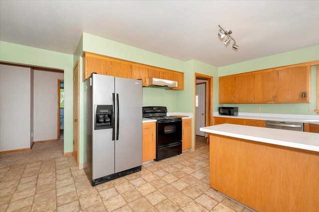 kitchen with rail lighting and black appliances