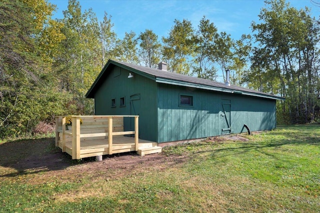 view of outbuilding with a lawn