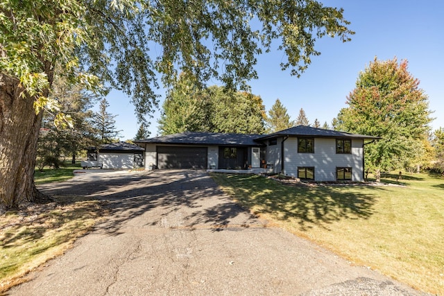 view of front facade with a front yard and a garage