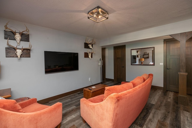 living room with a textured ceiling and dark hardwood / wood-style flooring