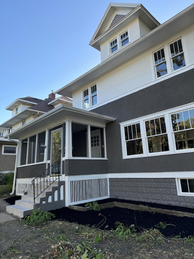 view of front of house with a sunroom