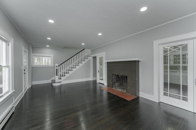 unfurnished living room with a fireplace, crown molding, dark hardwood / wood-style flooring, and a baseboard radiator