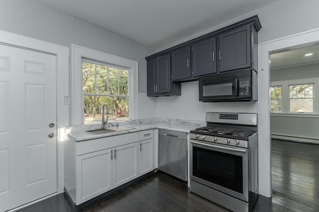 kitchen featuring a baseboard radiator, sink, stainless steel appliances, and dark hardwood / wood-style flooring