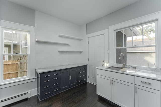 kitchen with white cabinets, a baseboard radiator, dark wood-type flooring, and sink