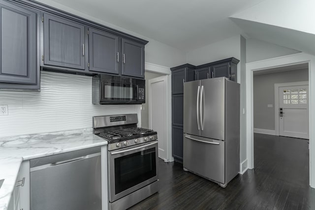 kitchen featuring light stone counters, decorative backsplash, stainless steel appliances, dark hardwood / wood-style flooring, and gray cabinets