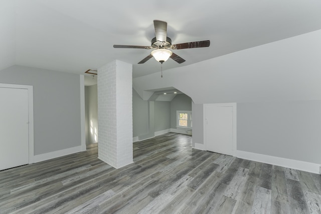 bonus room featuring lofted ceiling, dark hardwood / wood-style floors, and ceiling fan