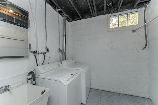 clothes washing area featuring sink and washer and dryer