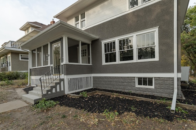 view of side of property featuring a sunroom