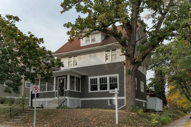 view of front of house featuring a sunroom