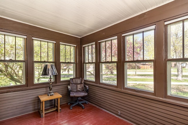sunroom / solarium with wood finished floors and wood walls