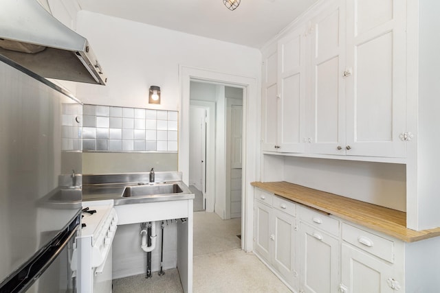 kitchen with stainless steel counters and white cabinetry
