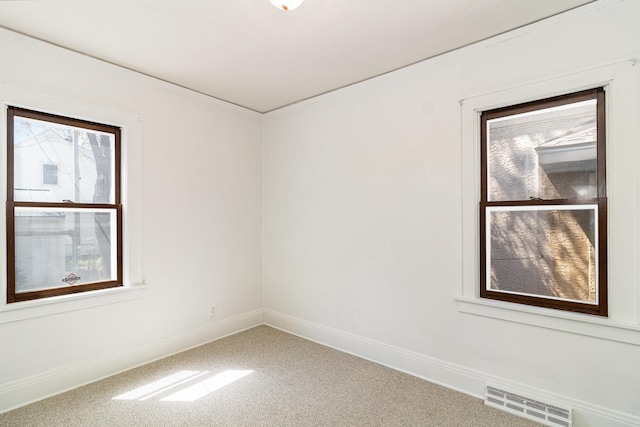 unfurnished room featuring carpet and baseboards
