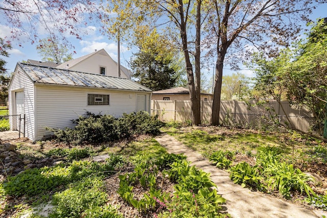 view of yard with fence and an outdoor structure