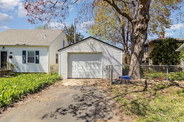 detached garage with driveway and fence