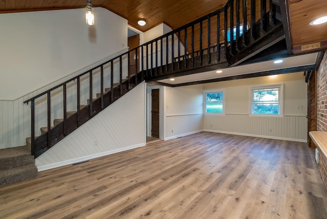 unfurnished living room featuring wood ceiling, vaulted ceiling, and hardwood / wood-style flooring