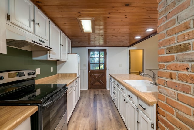 kitchen featuring light wood-type flooring, stainless steel electric range oven, sink, and white cabinetry