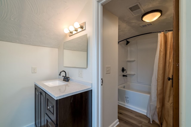 bathroom featuring vanity, hardwood / wood-style floors, and shower / bathtub combination with curtain