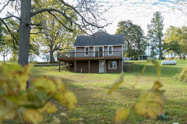 back of house with a wooden deck and a yard