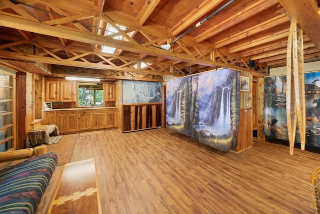 miscellaneous room with beam ceiling, light hardwood / wood-style flooring, and sink