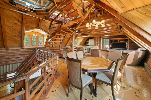 dining area with vaulted ceiling, wooden walls, and hardwood / wood-style flooring