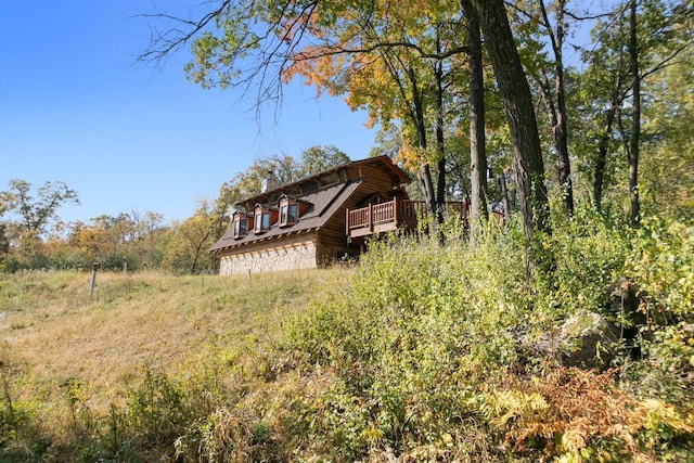 view of side of home featuring a wooden deck