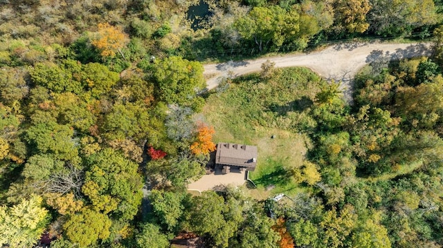 drone / aerial view with a wooded view