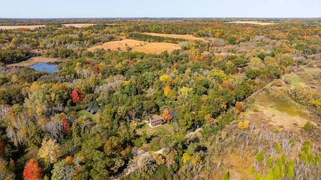 bird's eye view with a water view and a wooded view