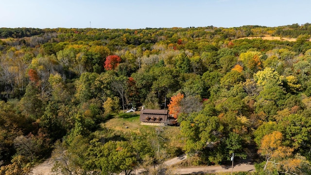 drone / aerial view with a wooded view