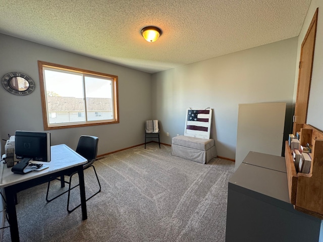 carpeted office featuring a textured ceiling