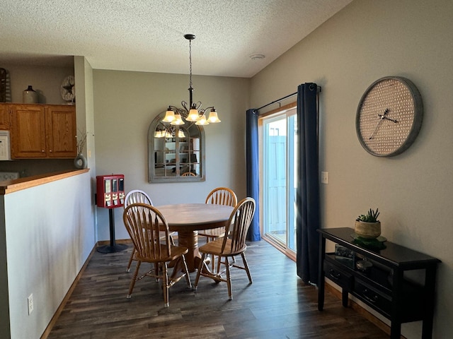 dining room featuring a chandelier, a textured ceiling, and dark hardwood / wood-style floors