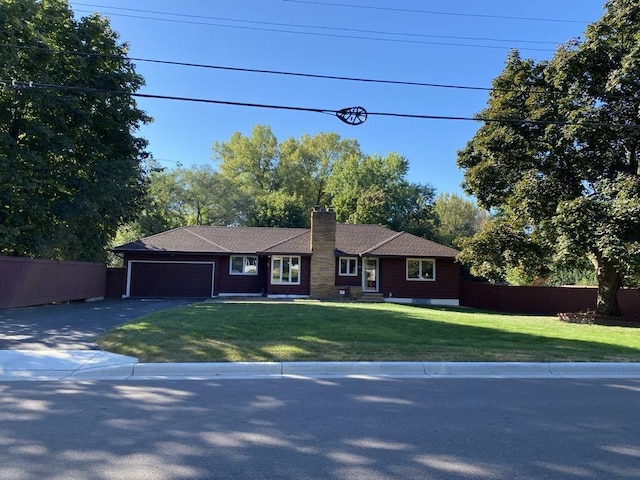 ranch-style house with a front yard and a garage