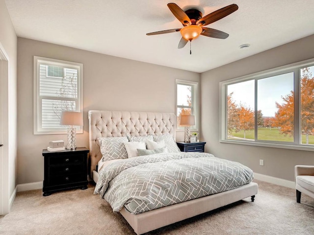 bedroom featuring light carpet and ceiling fan