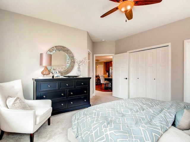 carpeted bedroom featuring a closet and ceiling fan