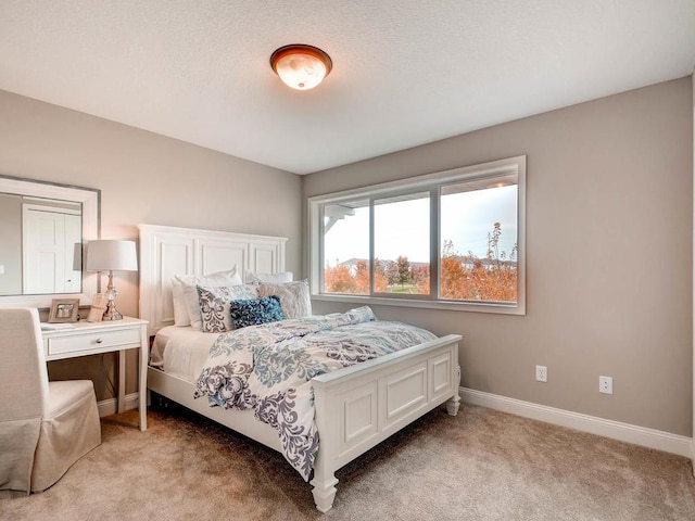 carpeted bedroom featuring a textured ceiling