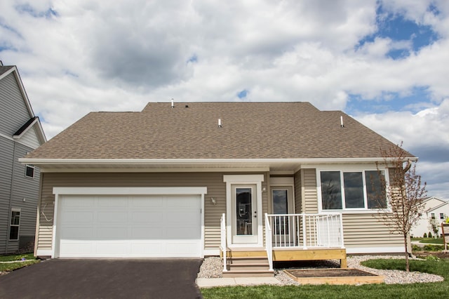 view of front of property with covered porch and a garage