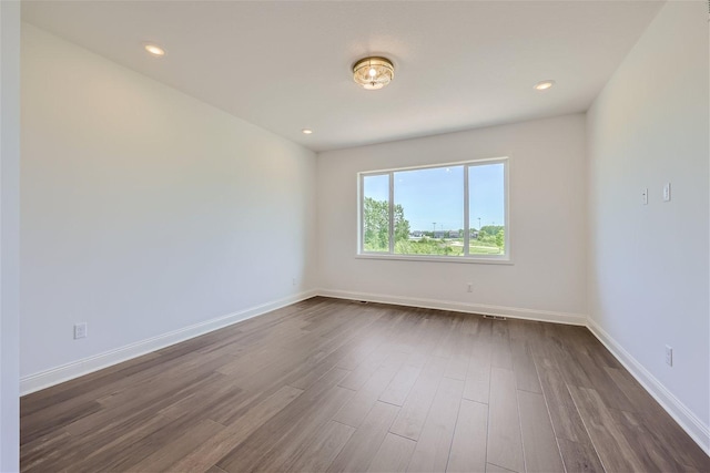 empty room featuring dark wood-type flooring