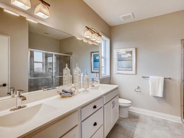 bathroom with a wealth of natural light, vanity, toilet, and a shower with door