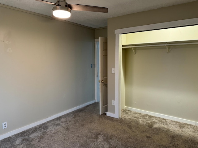 unfurnished bedroom featuring a textured ceiling, carpet floors, a closet, and ceiling fan