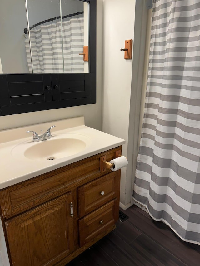 bathroom with vanity, a shower with shower curtain, and hardwood / wood-style flooring