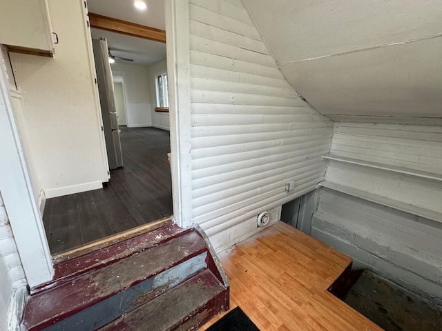 interior space featuring wood-type flooring and stainless steel fridge