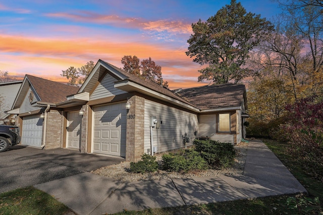 property exterior at dusk with a garage