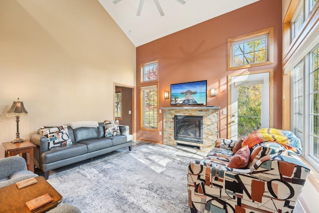 living room with high vaulted ceiling, a fireplace, and ceiling fan