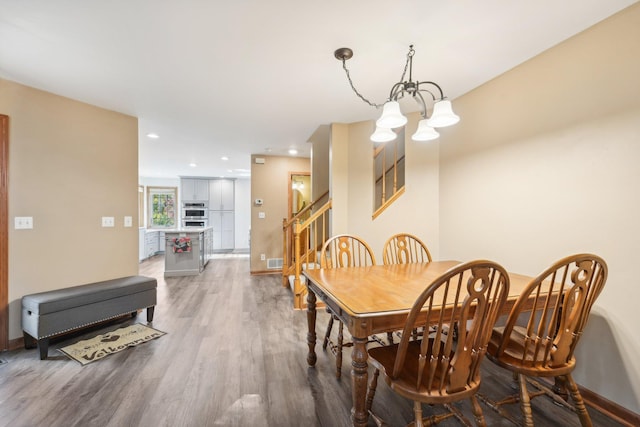 dining room featuring a notable chandelier and hardwood / wood-style flooring